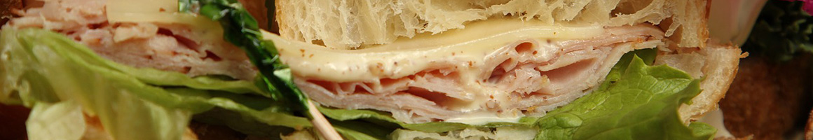 Eating Deli Sandwich at Luigi's Italian Deli restaurant in Baltimore, MD.